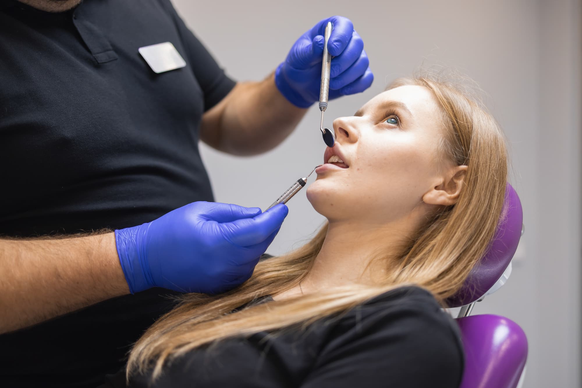 male-dentist-examining-female-patient-s-teeth-in-c-2023-11-27-05-24-48-utc.jpg